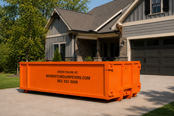 Orange Momentum dumpster placed in a residential driveway